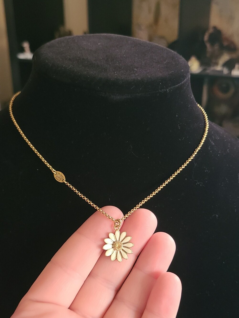 Juicy Couture Goldtone Daisy Pendant Necklace featuring a gold-tone chain